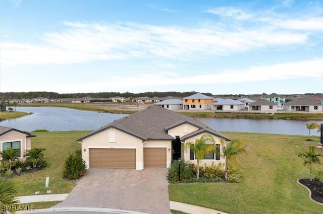 single story home with a water view, a front yard, and a garage