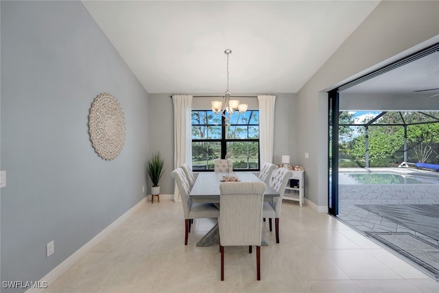 tiled dining space featuring an inviting chandelier, plenty of natural light, and lofted ceiling