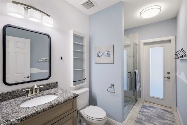 bathroom with vanity, a shower with shower door, and toilet