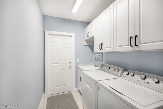 clothes washing area with cabinets, independent washer and dryer, sink, and light tile patterned floors