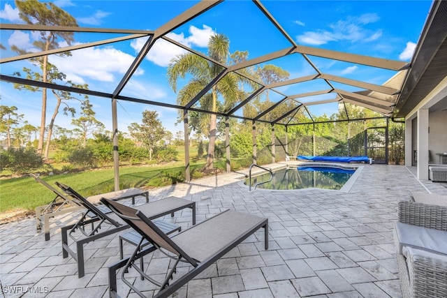 view of patio featuring a swimming pool with hot tub and glass enclosure