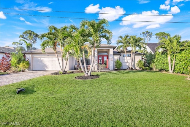 view of front of property featuring a front yard, french doors, and a garage