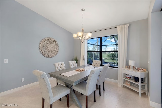 dining space with light tile patterned floors and an inviting chandelier