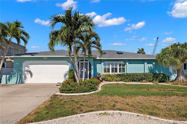 ranch-style house with a garage and a front lawn