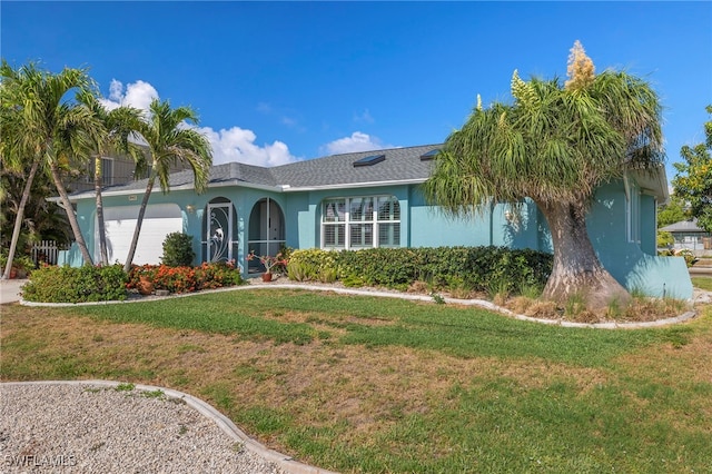 view of front of property with a front lawn and a garage