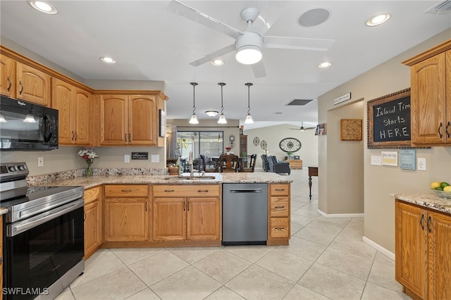 kitchen featuring light stone countertops, ceiling fan, sink, and stainless steel appliances