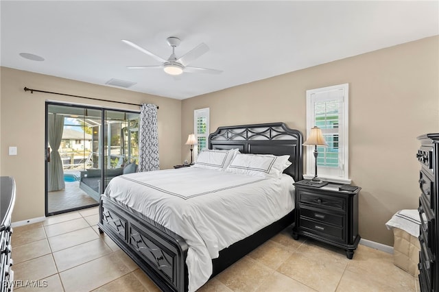 tiled bedroom featuring ceiling fan, access to outside, and multiple windows