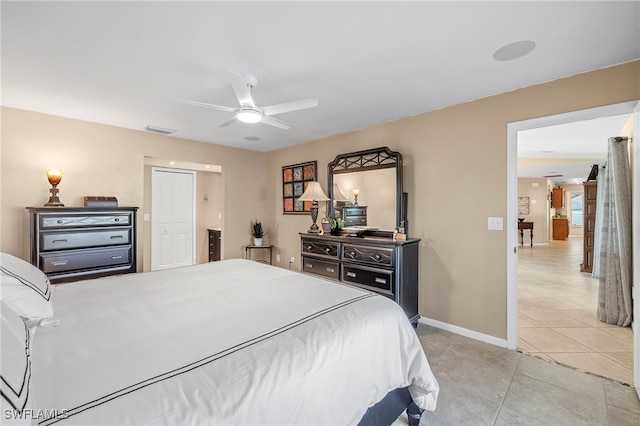 bedroom with ceiling fan and light tile patterned floors