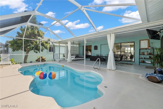 view of swimming pool with ceiling fan, a lanai, and a patio