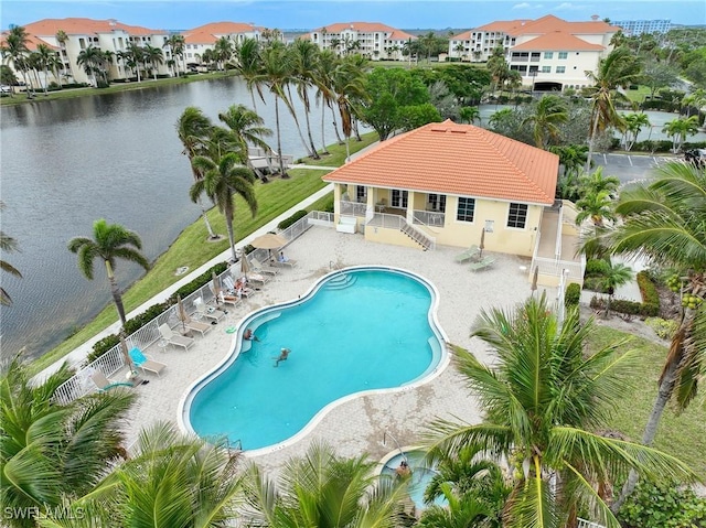 view of pool with a water view and a patio