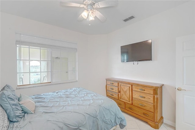 tiled bedroom with ceiling fan