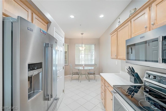 kitchen featuring pendant lighting, light brown cabinets, light tile patterned floors, and stainless steel appliances