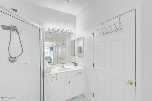 bathroom with tile patterned flooring, vanity, and an enclosed shower