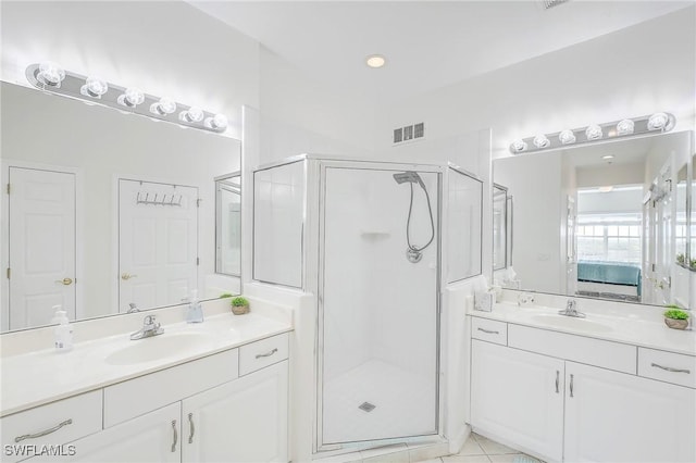 bathroom featuring tile patterned floors, vanity, and a shower with door