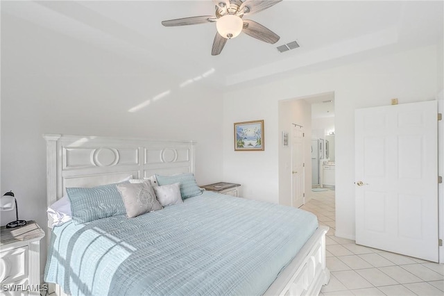 bedroom with connected bathroom, ceiling fan, and light tile patterned floors