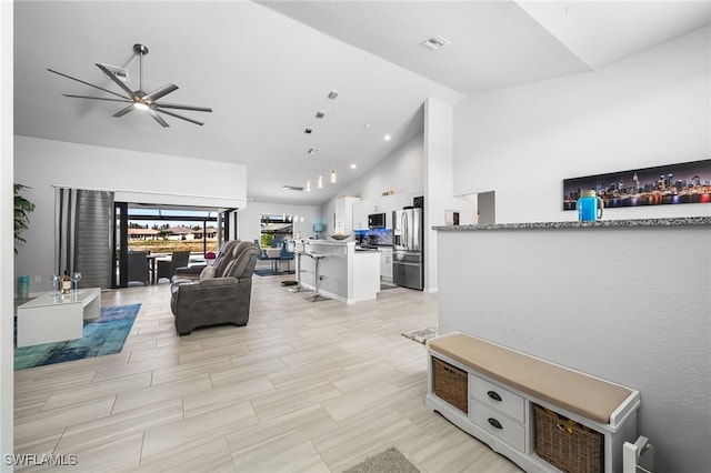 living room featuring high vaulted ceiling and ceiling fan