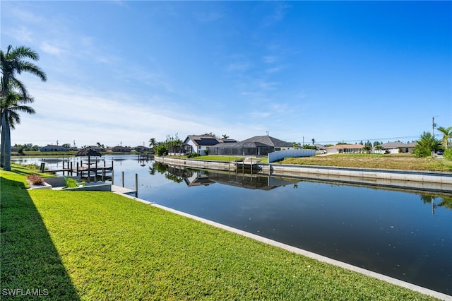 dock area featuring a water view and a yard