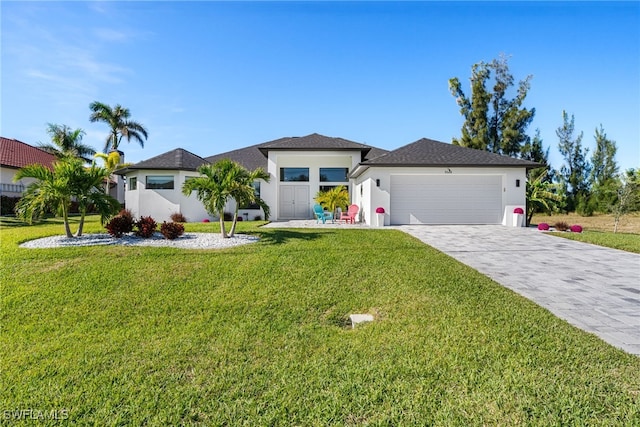 view of front of property featuring a garage and a front yard