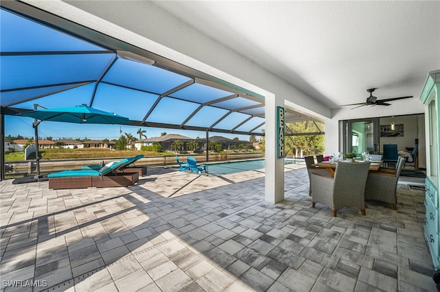 view of patio with ceiling fan and a lanai