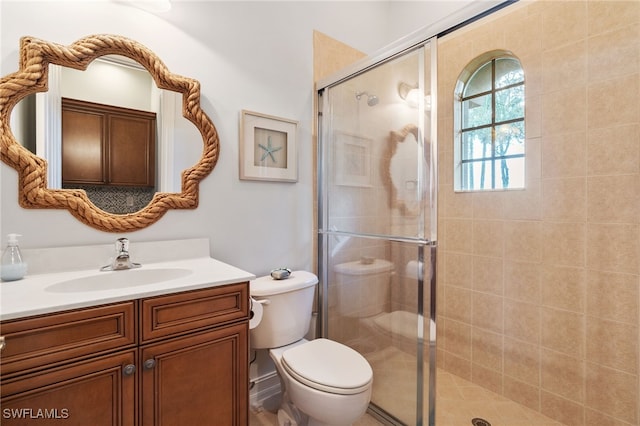 bathroom featuring walk in shower, vanity, and toilet