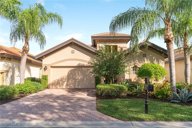 mediterranean / spanish home featuring a garage