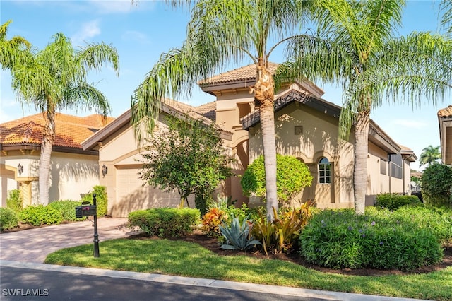 mediterranean / spanish-style house with a garage