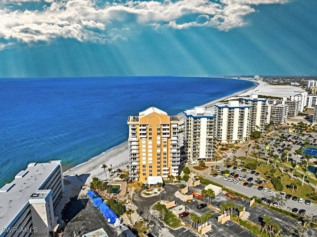 drone / aerial view featuring a water view and a beach view