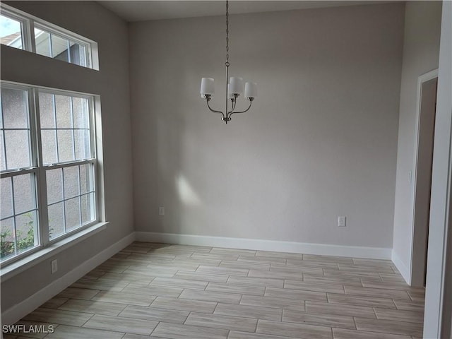 unfurnished dining area with a notable chandelier