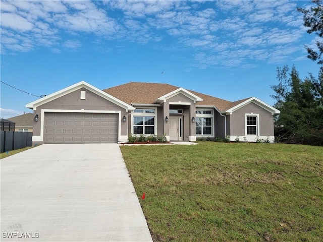 single story home featuring a garage and a front yard