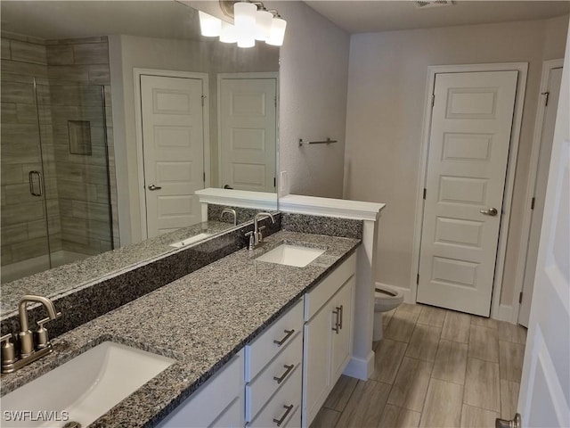 bathroom featuring walk in shower, vanity, and toilet