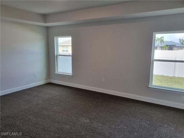 empty room with dark carpet