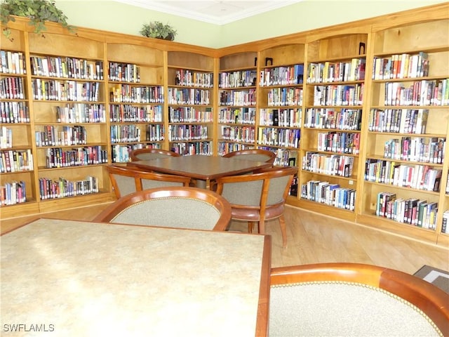 living area featuring hardwood / wood-style floors and ornamental molding