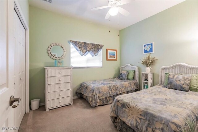 bedroom featuring ceiling fan, a closet, and carpet