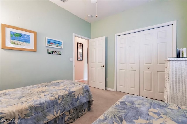 bedroom featuring a closet and light colored carpet