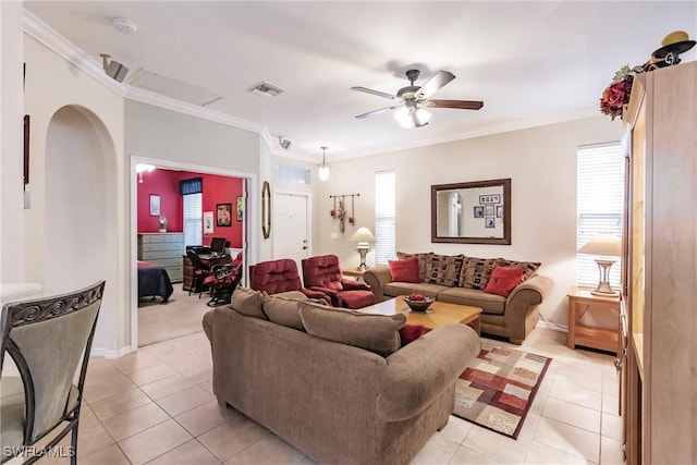 living room with light tile patterned floors, ceiling fan, crown molding, and a healthy amount of sunlight