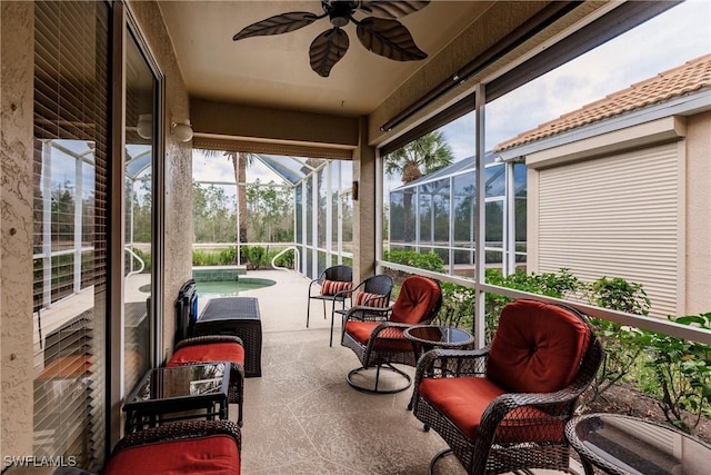 sunroom / solarium featuring ceiling fan