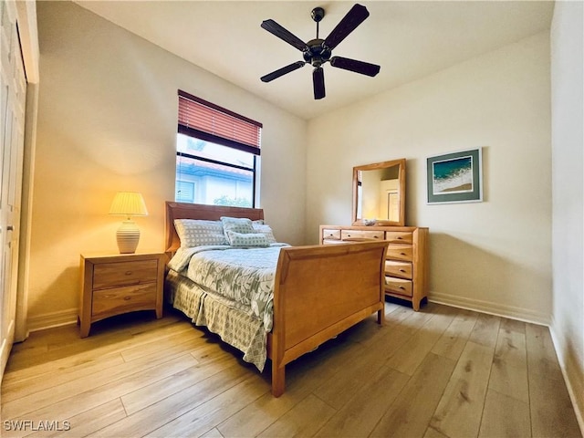 bedroom with ceiling fan, a closet, and light hardwood / wood-style floors