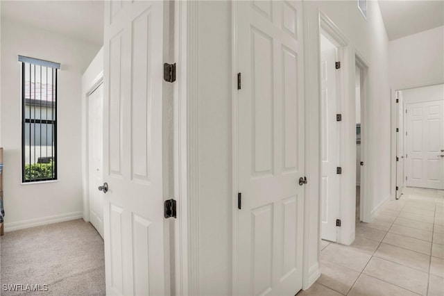 corridor featuring a wealth of natural light and light tile patterned flooring