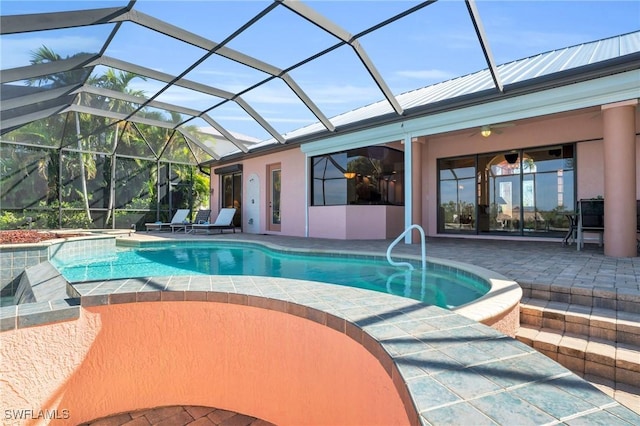 view of swimming pool with ceiling fan, a patio area, and a lanai