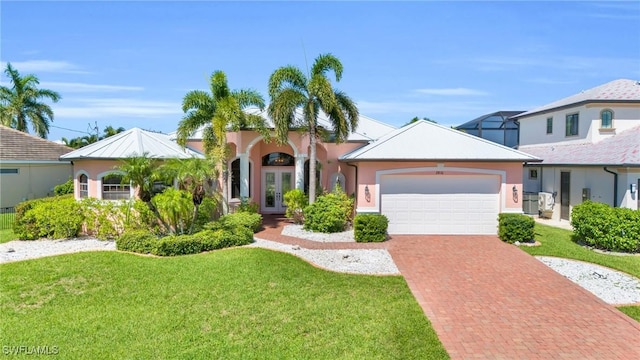 view of front of house featuring a front yard, french doors, and a garage