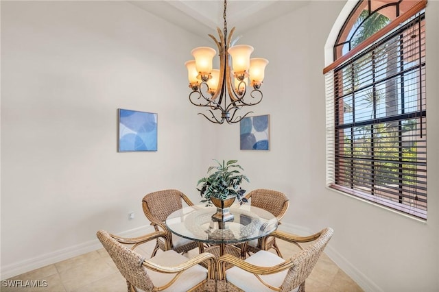 tiled dining room featuring an inviting chandelier