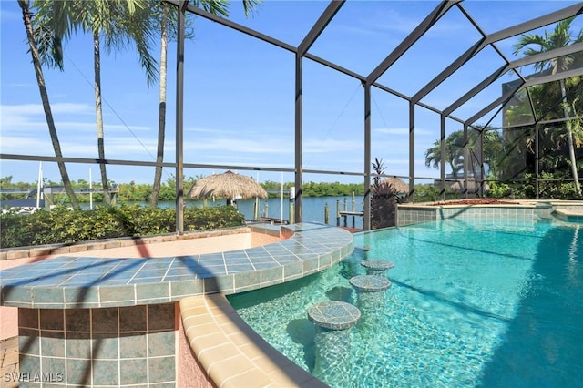 view of pool with a boat dock, a water view, and a lanai