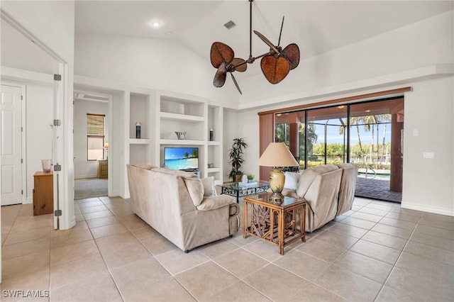 tiled living room with ceiling fan, built in features, and high vaulted ceiling