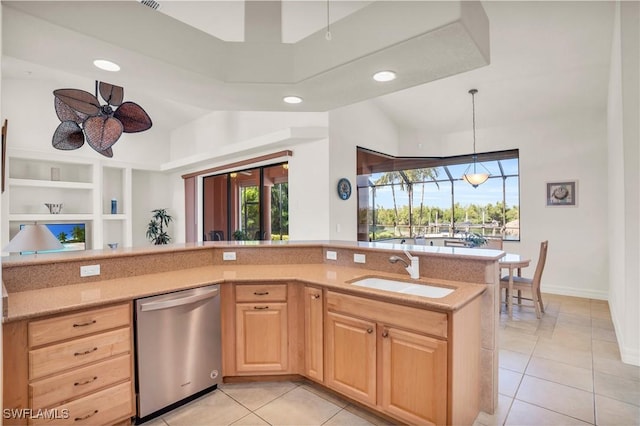 kitchen featuring sink, stainless steel dishwasher, ceiling fan, built in features, and light tile patterned floors