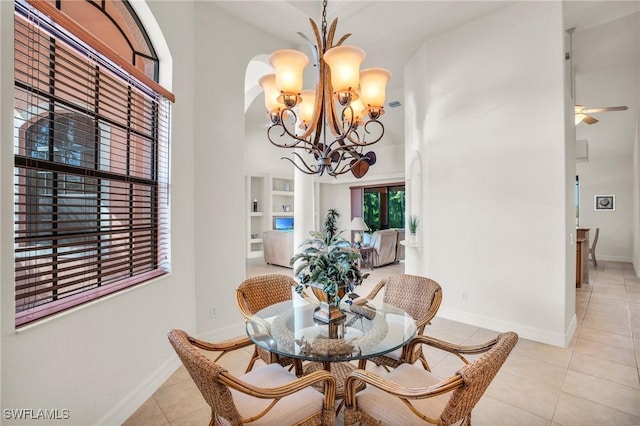 dining room with light tile patterned floors and ceiling fan with notable chandelier