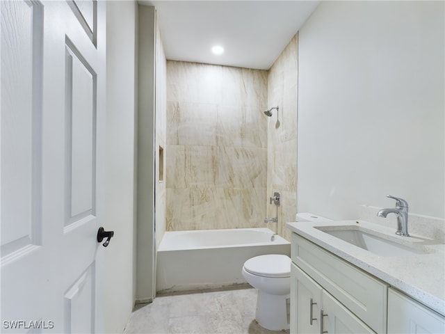 full bathroom featuring tiled shower / bath combo, toilet, and vanity