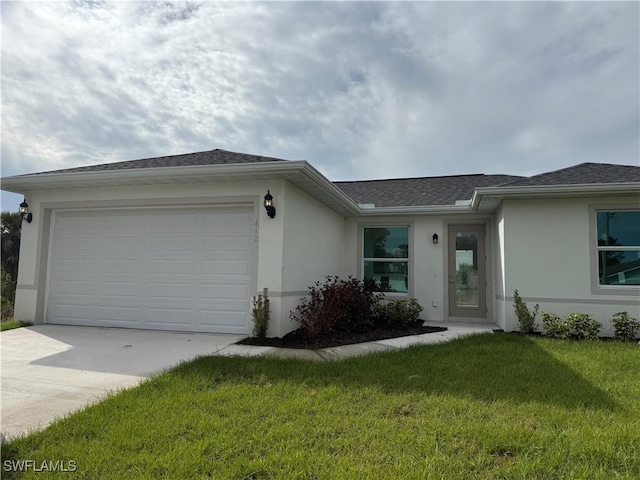 single story home featuring a garage and a front yard