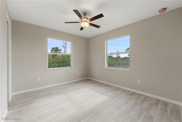 spare room with ceiling fan and light hardwood / wood-style flooring