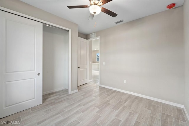 unfurnished bedroom featuring a closet, ceiling fan, and light hardwood / wood-style flooring