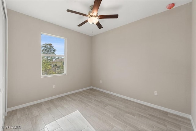 spare room with ceiling fan and light wood-type flooring